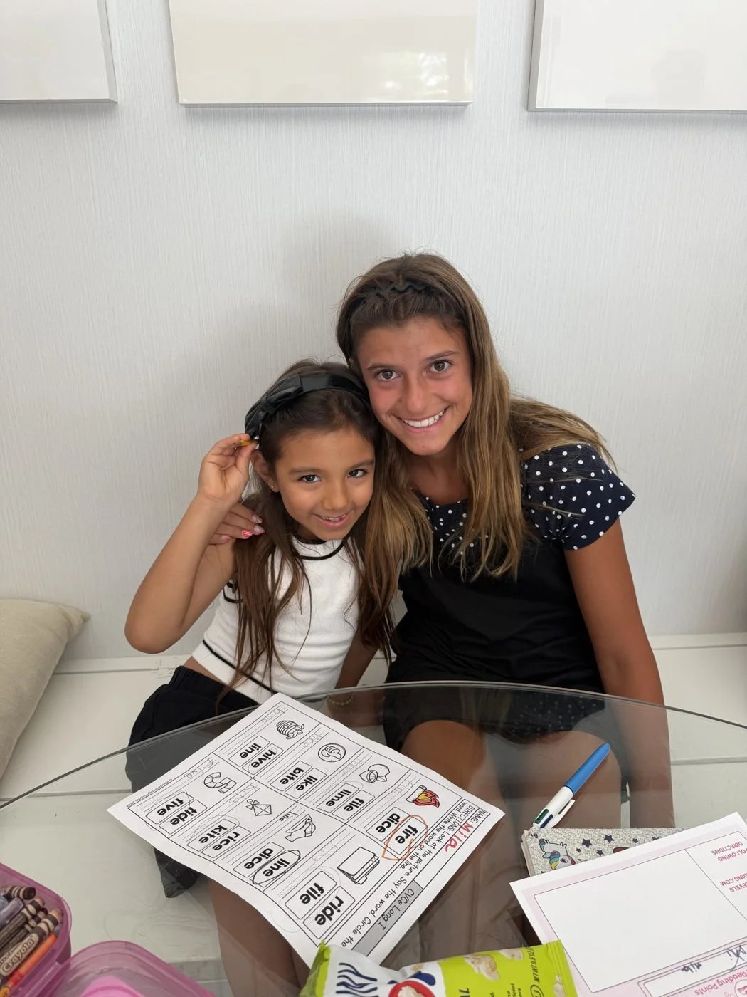 Capri reading one-on-one with a little girl at home
